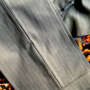 Grey pinstripe suit. Jacket is a 42 long and pants are a size 36.
